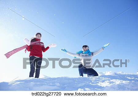 Stock Image - cordial couple having fun in ski resort with big smile. Fotosearch