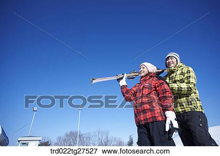 Stock Photo - cordial couple having fun in ski resort. Fotosearch