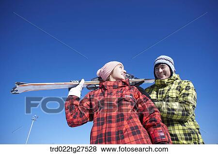 Stock Photo - cordial couple having fun in ski resort. Fotosearch