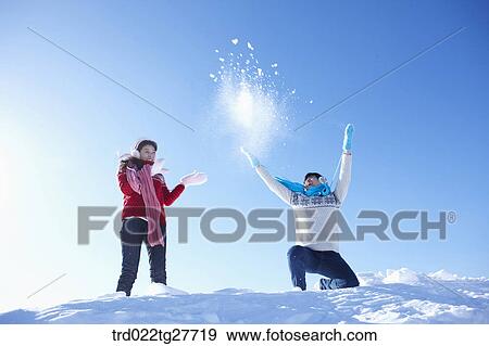Stock Photo - cordial couple having fun in ski resort with big smile. Fotosearch