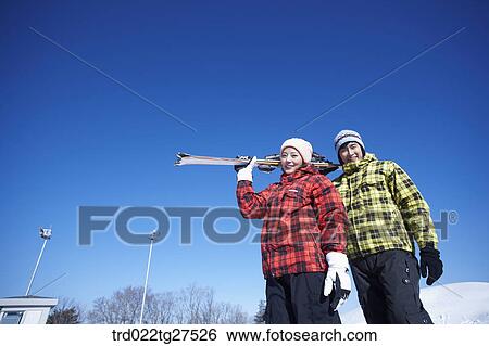 Stock Photograph - cordial couple having fun in ski resort. Fotosearch