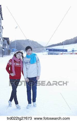 cordial couple holding hands in same clothing View Large Photo Image Stock Image - cordial couple holding hands in same clothing. Fotosearch
