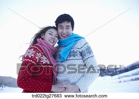 Stock Image - cordial couple holding hands in same clothing. Fotosearch