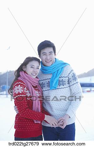 cordial couple holding hands in same clothing View Large Photo Image Stock Photo - cordial couple holding hands in same clothing. Fotosearch