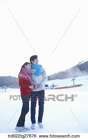 cordial couple holding hands in same clothing View Large Photo Image Stock Photograph - cordial couple holding hands in same clothing. Fotosearch