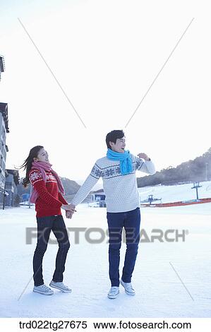 cordial couple holding hands in same clothing View Large Photo Image Stock Photography - cordial couple holding hands in same clothing. Fotosearch