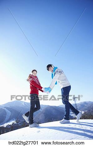 Stock Image - cordial couple holding hands together. Fotosearch