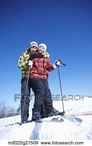 Stock Photo - cordial couple in ski resort. Fotosearch