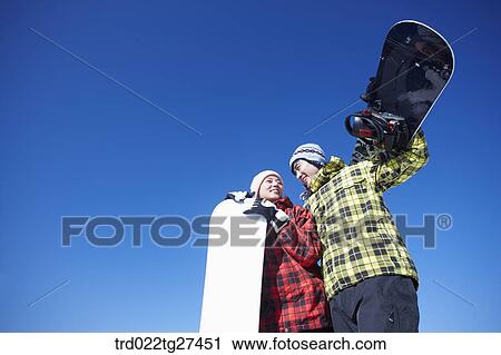Stock Image - couple enjoying snow board. Fotosearch