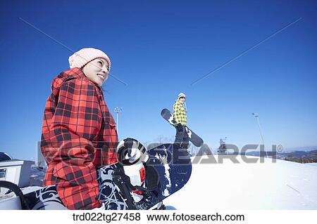 Stock Photo - couple enjoying snow board. Fotosearch