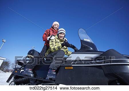 couple riding a motor ski vehicle View Large Photo Image Picture - couple riding a motor ski vehicle. Fotosearch