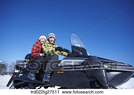 couple riding a motor ski vehicle View Large Photo Image Stock Image - couple riding a motor ski vehicle. Fotosearch