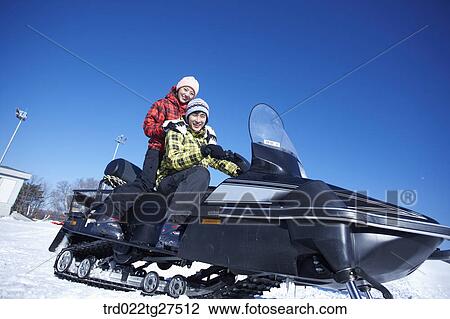 couple riding a motor ski vehicle View Large Photo Image Stock Image - couple riding a motor ski vehicle. Fotosearch