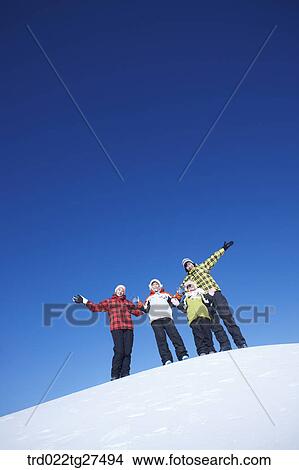 Picture - family having fun in ski resort. Fotosearch