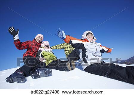 Stock Photo - family having fun in ski resort. Fotosearch