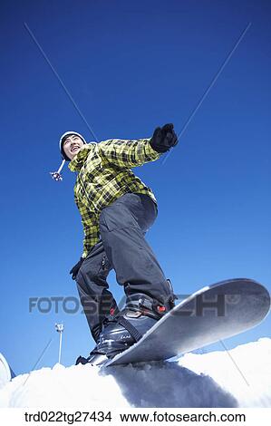 Picture - man enjoying snow board. Fotosearch
