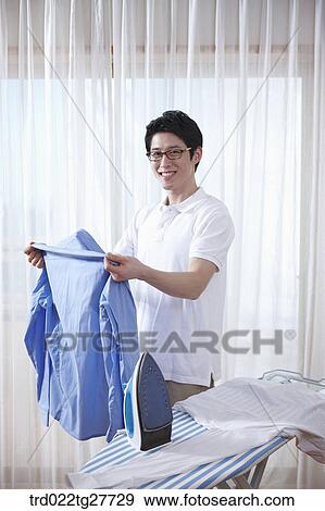 man ironing his shirt View Large Photo Image Stock Photo - man ironing his shirt. Fotosearch