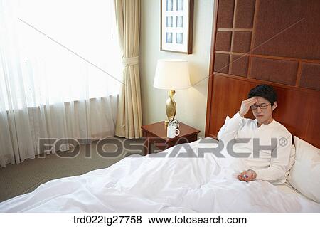 man on the bed has pain and pills View Large Photo Image Stock Photo - man on the bed has pain and pills. Fotosearch