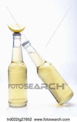 Stock Image - bottled beer with lemon slice. Fotosearch