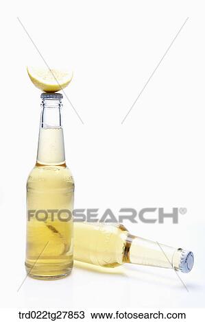 Stock Image - bottled beer with lemon slice. Fotosearch
