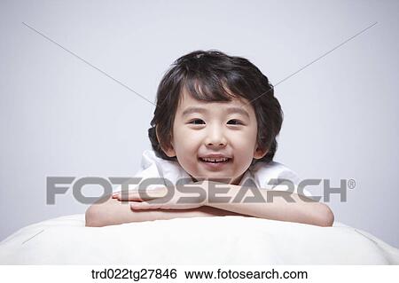 children education boy lay face down on the pillow View Large Photo Image Stock Photograph - children education boy lay face down on the pillow. Fotosearch