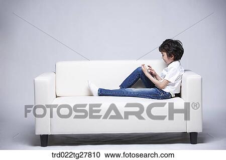 Stock Image - children education boy using tablet pc. Fotosearch
