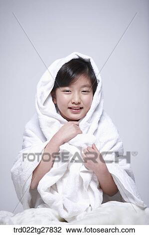 Stock Image - children education girl covered herself with a blanket. Fotosearch