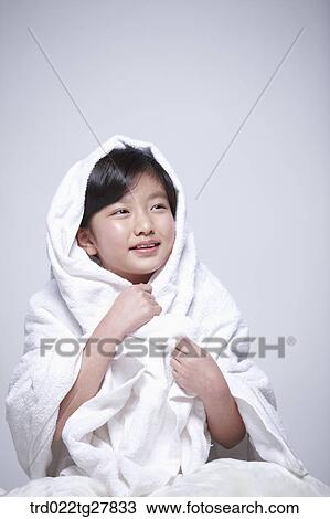 Stock Image - children education girl covered herself with a blanket. Fotosearch