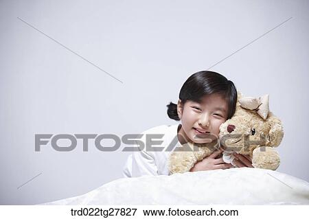 children education girl lay face down holding teddy bear View Large Photo Image Stock Photo - children education girl lay face down holding teddy bear. Fotosearch