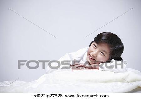 children education girl lay face down on bed View Large Photo Image Stock Photograph - children education girl lay face down on bed. Fotosearch