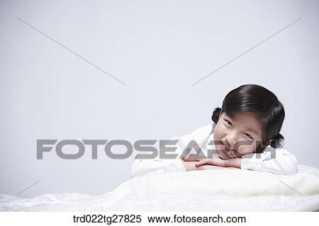 children education girl lay face down on bed View Large Photo Image Stock Photography - children education girl lay face down on bed. Fotosearch