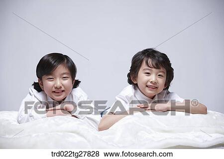 children education lay face down on bed together View Large Photo Image Stock Photo - children education lay face down on bed together. Fotosearch