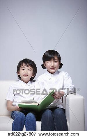 children education reading a book on couch View Large Photo Image Stock Photo - children education reading a book on couch. Fotosearch