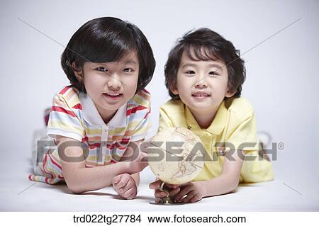 Picture - children education touching globe. Fotosearch