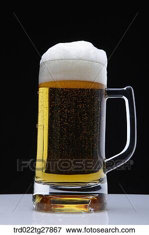 Stock Photo - draft beer with foams. Fotosearch