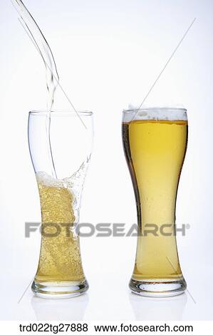 Stock Photo - pour draft beer into glass. Fotosearch