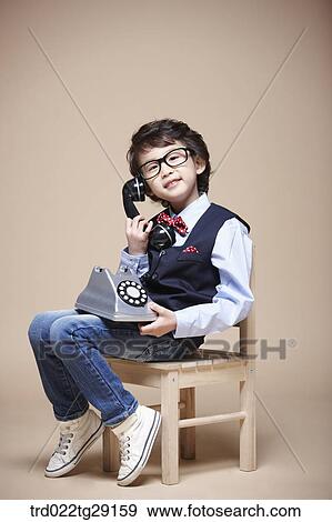 Stock Photo - boy answering the phone. Fotosearch