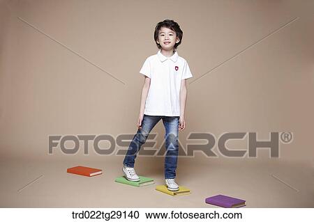 Stock Image - boy crosses stepping stones. Fotosearch