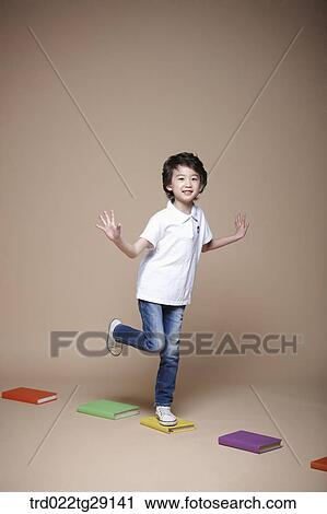 Stock Image - boy crosses stepping stones. Fotosearch