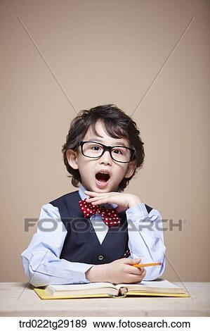 Stock Photo - boy is studying. Fotosearch