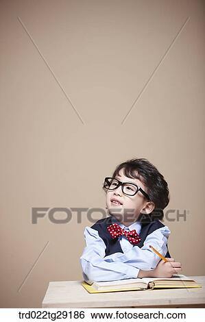 Stock Photograph - boy is studying. Fotosearch