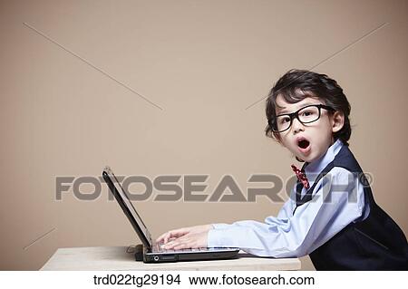 Picture - boy is studying using laptop. Fotosearch