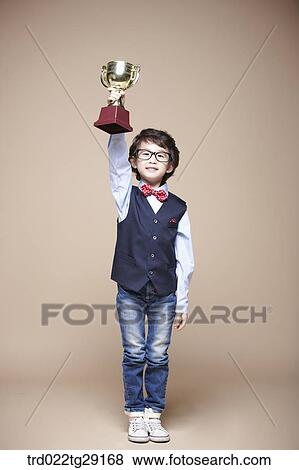 boy pick up the trophy View Large Photo Image Stock Photo - boy pick up the trophy . Fotosearch