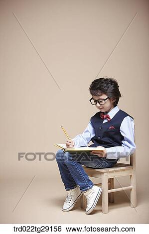 boy studying on chair View Large Photo Image Stock Photograph - boy studying on chair. Fotosearch