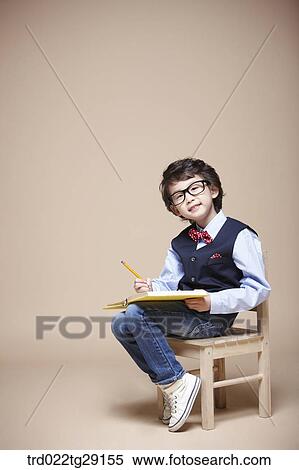 boy studying on chair View Large Photo Image Stock Photography - boy studying on chair. Fotosearch