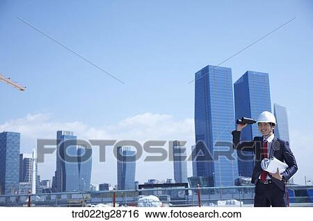 Stock Photograph - business man looking over the telescope. Fotosearch