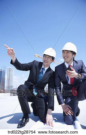 business people at construction site are in confidence View Large Photo Image Picture - business people at construction site are in confidence. Fotosearch