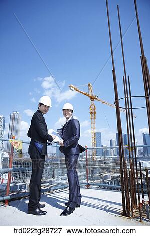 business people at construction site are in confidence View Large Photo Image Stock Photo - business people at construction site are in confidence. Fotosearch