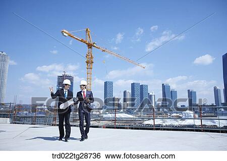 business people walking at construction site View Large Photo Image Stock Photograph - business people walking at construction site. Fotosearch