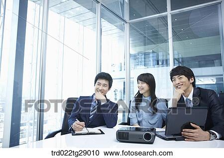 Stock Image - business people working together in office. Fotosearch